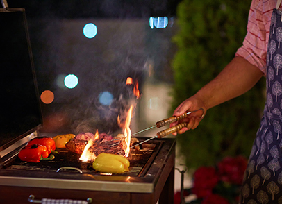Person's Hand Barbecuing Food