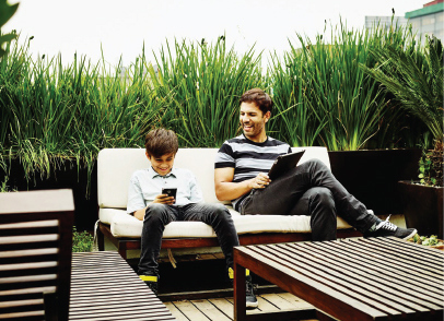 Father and Son Enjoy Sitting in a Garden