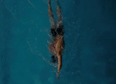 A Man Swimming In A Swimming Pool