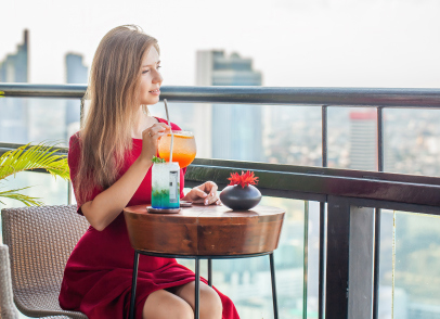 A Woman Enjoying Drinks In A Terrace