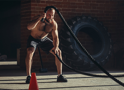 A person plays a battle rope workout